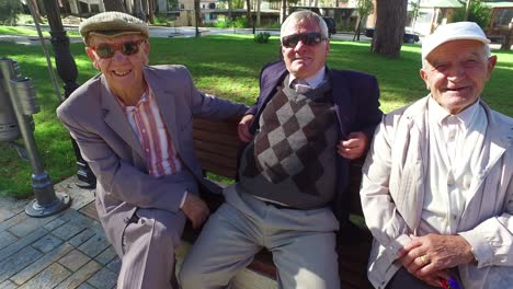 Albanian-men-sit-on-a-bench-in-the-park-and-enjoy-friendship-and-conversation