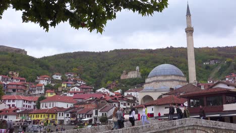 Establishing-shot-of-a-town-in-Kosovo-with-bridge-and-mosque-1