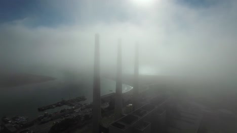 Amazing-aerial-over-large-power-plant-smokestacks-in-the-fog-near-Morro-Bay-California