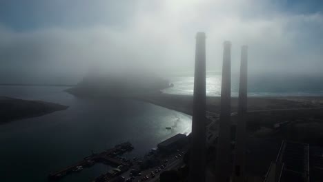 Amazing-aerial-over-large-power-plant-smokestacks-in-the-fog-near-Morro-Bay-California-2