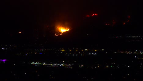 Out-of-control-wildfire-burns-behind-a-California-city-at-night