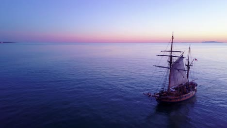 Spectacular-aerial-of-a-tall-sailing-ships-on-the-open-ocean-at-sunset-4