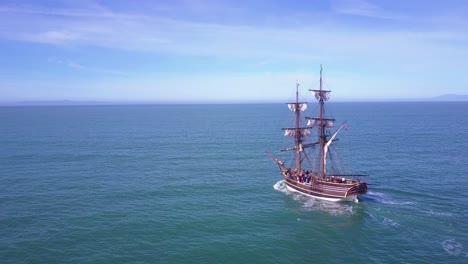 Spectacular-aerial-following-a-tall-sailing-ship-on-the-open-ocean-by-day-5