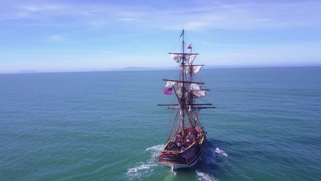 Spectacular-aerial-following-a-tall-sailing-ship-on-the-open-ocean-by-day-6