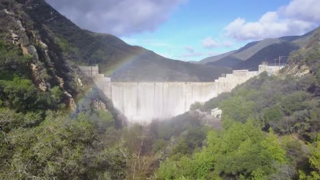 Beautiful-aerial-shot-over-a-dam-in-full-flood-stage-in-Ojai-California-with-rainbow-1