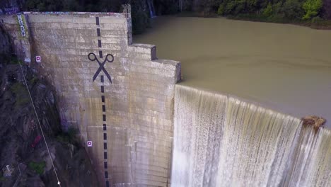 Beautiful-aerial-over-a-high-waterfall-or-dam-in-full-flood-stage-near-Ojai-California-13