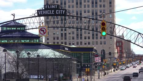 Establishing-shot-of-Flint-Michigan-main-street-and-arch-saying-Vehicle-City