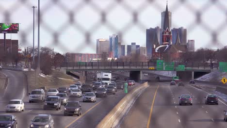Looking-through-a-chain-link-fence-at-a-large-church-and-freeway-near-downtown-Detroit-Michigan