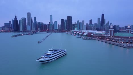 Eine-Wunderschöne-Antenne-Um-Den-Navy-Pier-In-Chicago-Mit-Der-Skyline-Der-Stadt-Im-Hintergrund-Nacht?