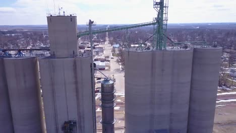 An-rising-aerial-along-grain-silos-reveals-a-small-American-Midwest-farming-town