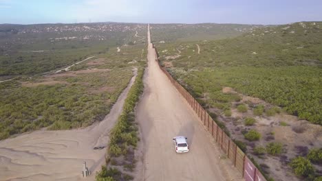 Aerial-over-a-border-patrol-vehicle-standing-guard-near-the-border-wall-at-the-US-Mexico-border-5