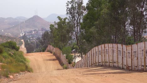 The-US-border-wall-fence-with-the-city-of-Tecate-Mexico-background-1