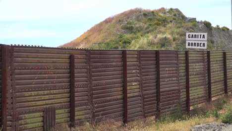 The-US-Mexico-border-wall-fence-with-a-sign-saying-border-in-background-1