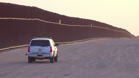Border-patrol-vehicle-moves-near-the-border-wall-at-the-US-Mexico-border-at-Imperial-sand-dunes-California