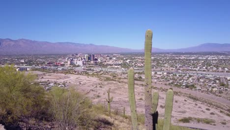 An-aerial-establishing-shot-past-cactus-of-Tucson-Arizona