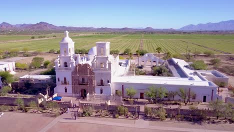 A-beautiful-aerial-establishing-shot-of-Mission-San-Xavier-del-Bac-a-historic-Spanish-Catholic-mission-near-Tucson-Arizona