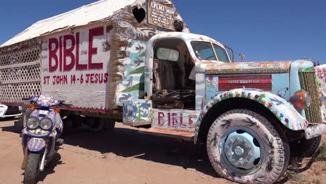A-truck-painted-with-Bible-verses-and-promoting-Jesus-sits-at-a-Christian-hippy-commune-at-Slab-City-California-1