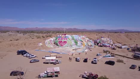Aerial-over-a-giant-hippy-Christian-art-installation-honors-Jesus-in-the-desert-in-Slab-City-California
