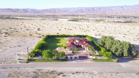 A-dramatic-aerial-reveals-a-large-mansion-in-miles-of-lonely-desert