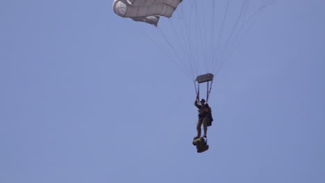 Elite-military-forces-and-paratroopers-skydive-onto-and-land-in-a-field-during-training-operations
