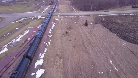 An-aerial-over-an-oil-train-with-tanks-cars-moving-rapidly-down-tracks