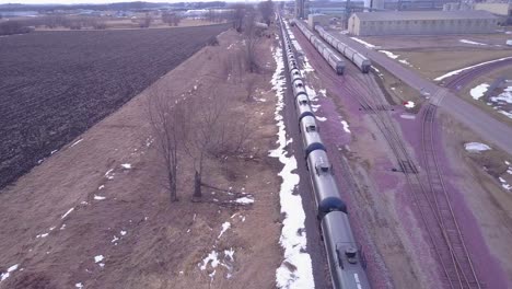 An-aerial-over-an-oil-train-with-tanks-cars-moving-rapidly-down-tracks-1
