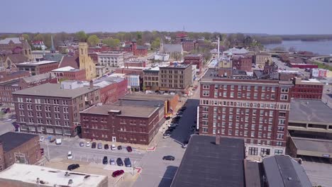 Rising-aerial-shot-over-small-town-America-Burlington-Iowa-downtown-with-Mississippi-River-background