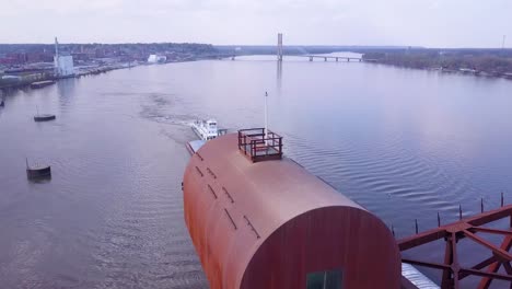 A-beautiful-aerial-of-a-barge-traveling-under-a-steel-drawbridge-on-the-Mississippi-River