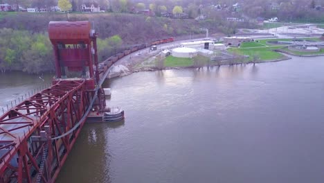 Aerial-of-a-coal-freight-train-crossing-a-long-suspension-bridge-over-the-Mississippi-River-1