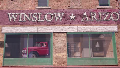 Establishing-shot-of-downtown-Winslow-Arizona-with-mural-depicting-a-flatbed-Ford-1