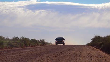 A-pickup-truck-drives-on-a-dirt-road