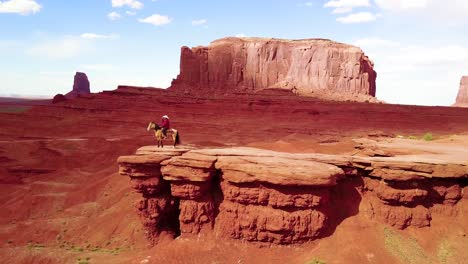 Remarkable-aerial-over-a-cowboy-on-horseback-overlooking-Monument-Valley-Utah