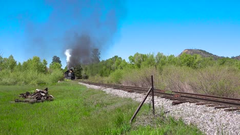 Low-of-the-Cumbres-and-Toltec-steam-train-moving-through-Colorado-mountains-near-Chama-New-Mexico
