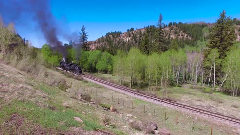 Cumbres-and-Toltec-steam-train-moving-through-Colorado-mountains-near-Chama-New-Mexico