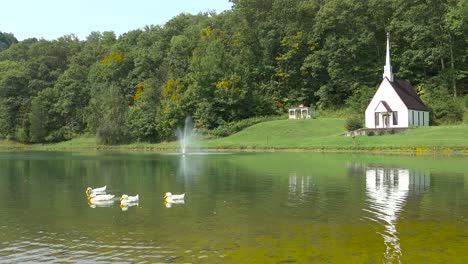 Swans-on-a-lake-in-front-of-a-romantic-and-beautiful-small-rural-church-in-the-American-wilderness-West-Virginia