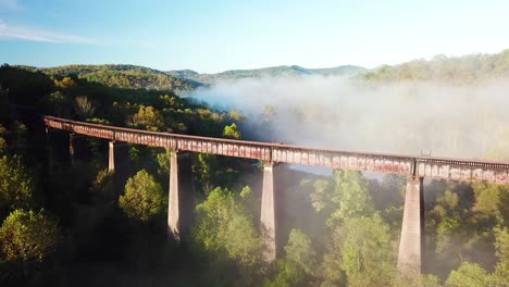 Beautiful-aerial-over-a-steel-railway-trestle-in-the-fog-in-West-Virginia-Appalachian-mountains-2