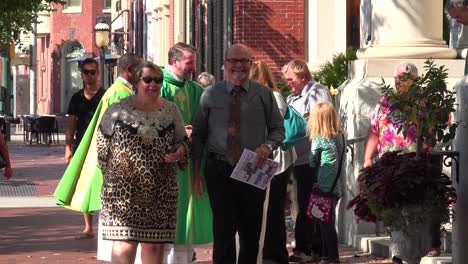 A-priest-greets-his-congregation-on-a-sunny-day-on-the-streets-of-Harrisburg-Pennsylvania
