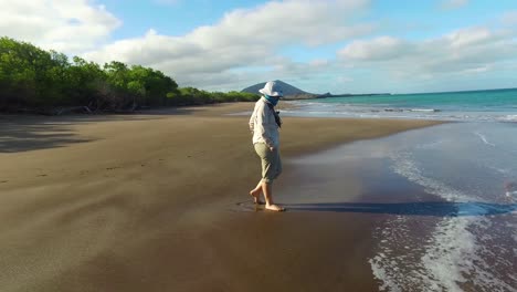 A-researcher-stands-on-a-beach-in-the-Galapagos-Islands-Ecuador