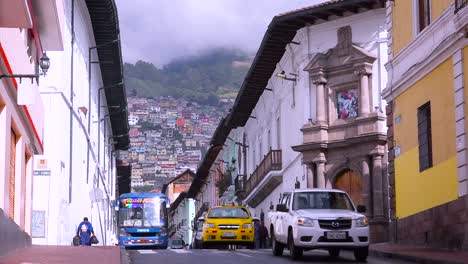 Busses-and-cars-travel-on-the-old-streets-of-Quito-Ecuador-1