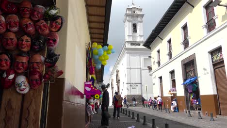 Pedestrians-walk-on-the-cobblestone-streets-of-Quito-Ecuador-with-pigeons-foreground-1