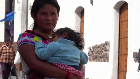 A-pretty-girl-from-Ecuador-stands-with-her-baby-on-the-streets-of-Quito