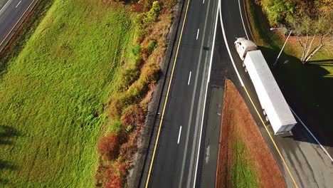 Aerial-of-a-semi-truck-traveling-on-a-highway-road-through-the-fog-in-fall-1