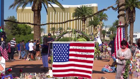 2017---thousands-of-candles-and-signs-form-a-makeshift-memorial-at-the-base-of-the-Welcome-to-Las-Vegas-sign-following-Americas-worst-mass-shooting-1