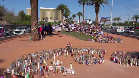 2017---thousands-of-candles-and-signs-form-a-makeshift-memorial-at-the-base-of-the-Welcome-to-Las-Vegas-sign-following-Americas-worst-mass-shooting-4