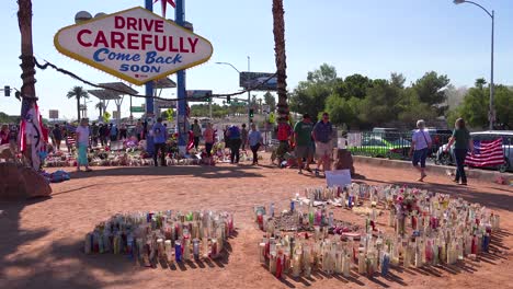 2017---thousands-of-candles-and-signs-form-a-makeshift-memorial-at-the-base-of-the-Welcome-to-Las-Vegas-sign-following-Americas-worst-mass-shooting-5