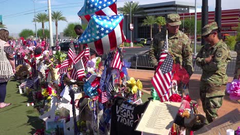 2017---thousands-of-candles-and-signs-form-a-makeshift-memorial-at-the-base-of-the-Welcome-to-Las-Vegas-sign-following-Americas-worst-mass-shooting-6