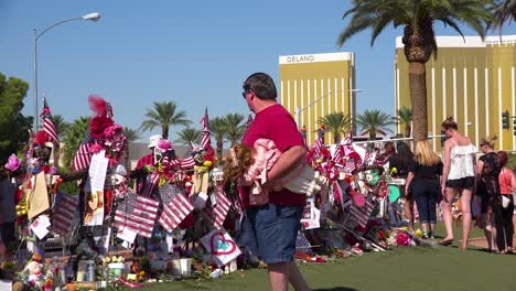 2017---thousands-of-candles-and-signs-form-a-makeshift-memorial-at-the-base-of-the-Welcome-to-Las-Vegas-sign-following-Americas-worst-mass-shooting-13