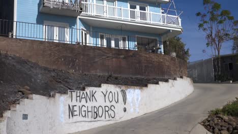 A-thank-you-to-neighbors-is-spray-painted-on-a-wall-outside-a-house-during-the-devastating-Thomas-Fire-in-Ventura-California