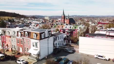 Rising-vista-aérea-of-typical-Pennsylvania-town-with-rowhouses-and-large-church-or-cathedral-distant-Reading-PA