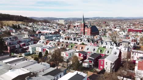 Aerial-of-typical-Pennsylvania-town-with-rowhouses-and-large-church-or-cathedral-distant-Reading-PA